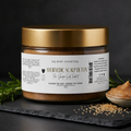 Jar of Ayurvedic Scalp Detox product with gold lid on a dark background