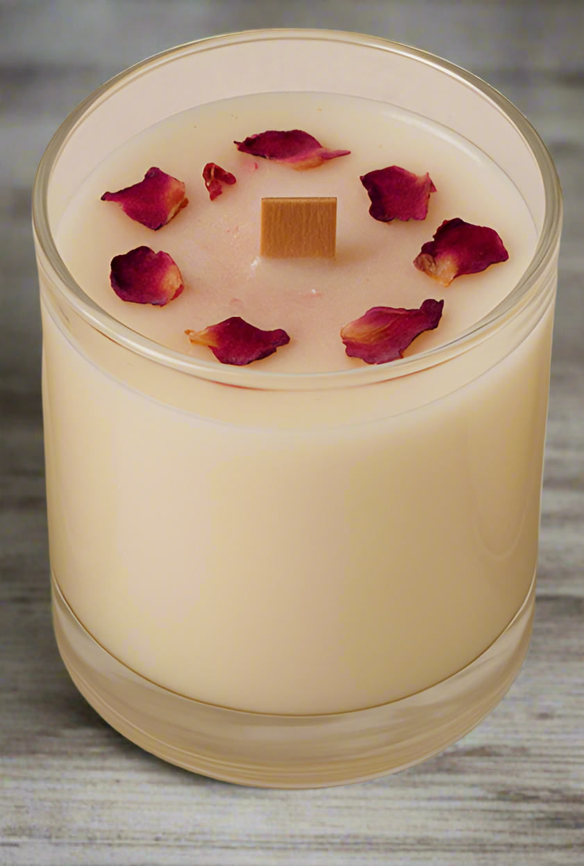 Three small candles in glass containers with decorative elements on a beige background