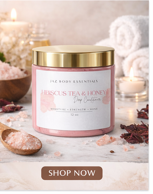 Jar of Jaz Body Essentials Hibiscus Tea & Honey Deep Conditioner on a marble surface with candles and sea salt in the background.